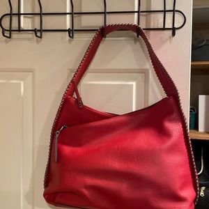 Red Inc bag with studded shoulder strap and sides.